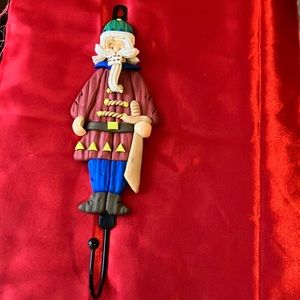 Clay man figure on metal hook red blue green white yellow brown tan